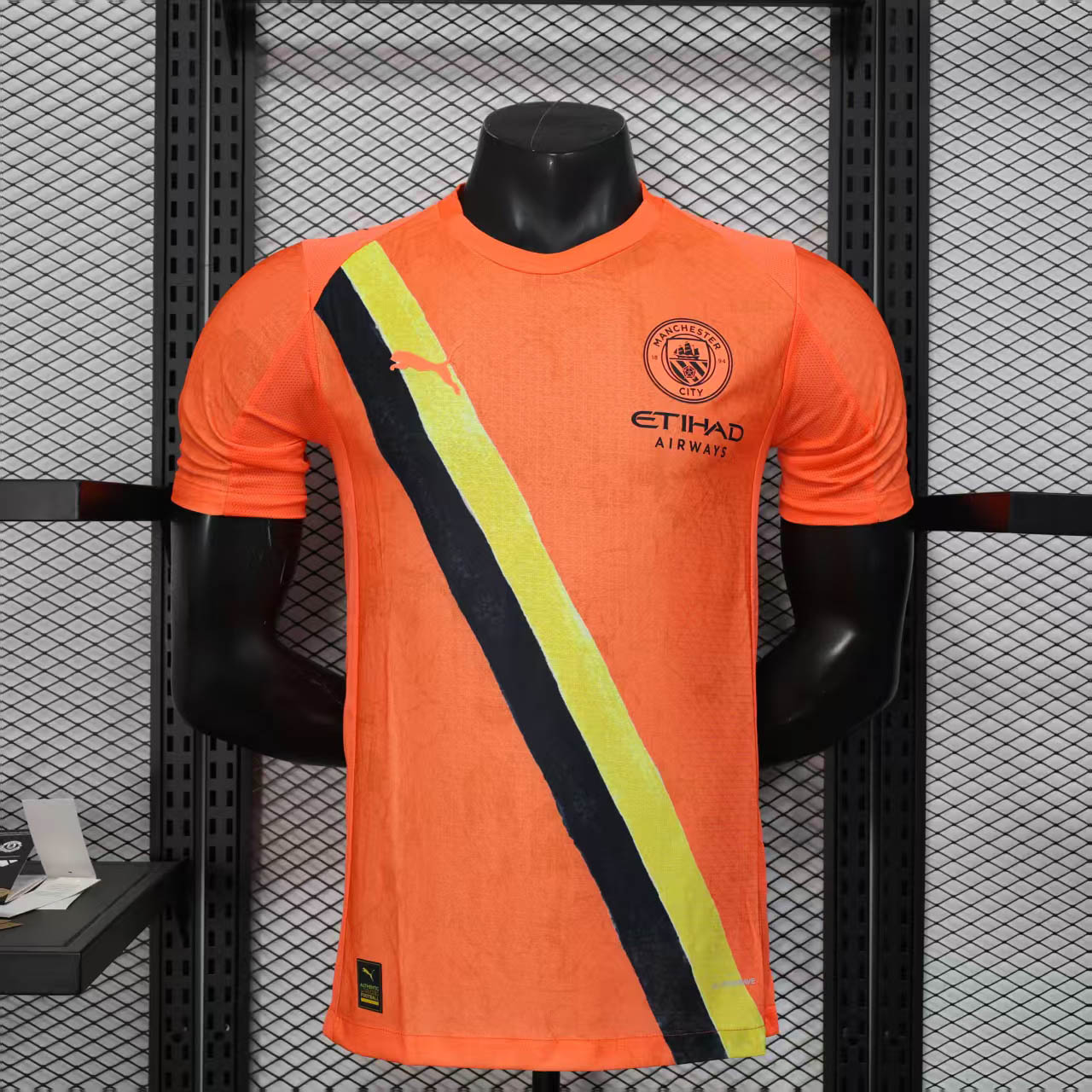 5436c02078d8a552fe0499c16b308b107ad6e386 2025/2026 Player Version Manchester City KidSuper Joint Edition Orange Football Shirt 1:1 Thai Quality - Image 1